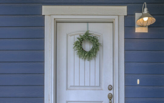 white front door blue house wreath on door